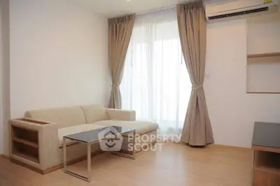 Modern minimalist living room with beige sofa and floor-to-ceiling curtains