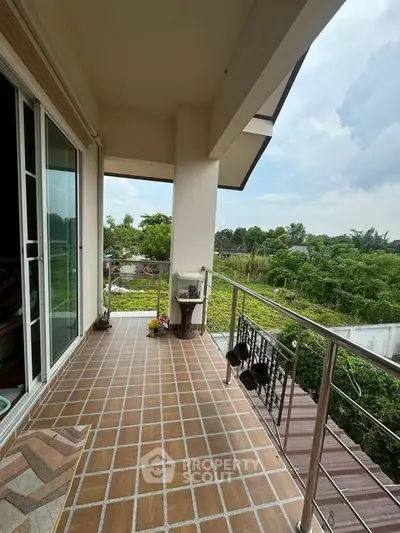 Spacious balcony with scenic garden view, perfect for relaxation and outdoor enjoyment.