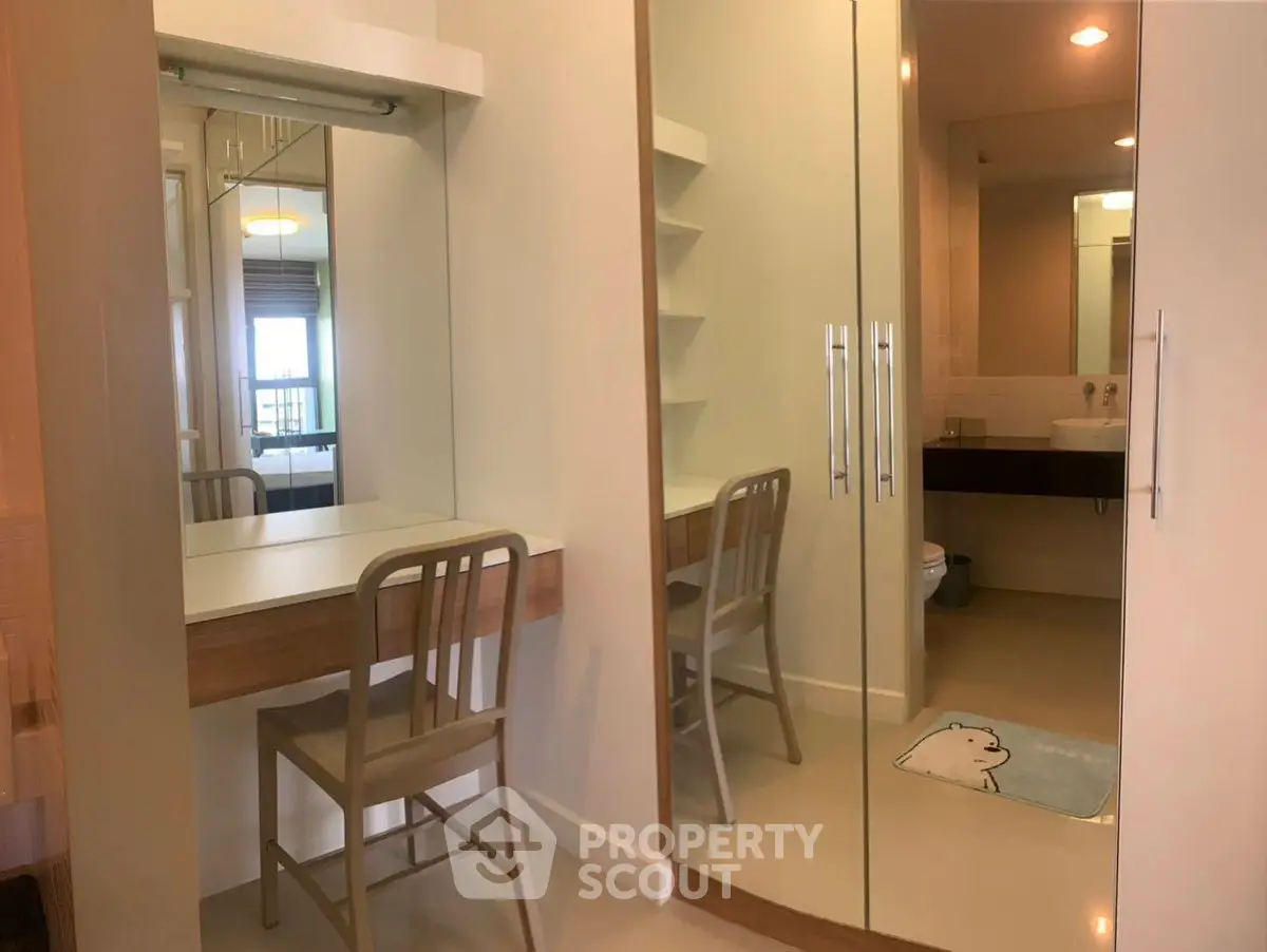 Modern bathroom with mirrored closet and vanity desk in stylish apartment
