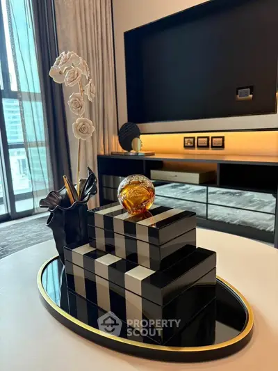 Elegant modern living room with stylish decor and large window view.