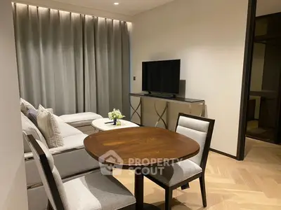 Modern living room with elegant furniture and flat-screen TV, perfect for cozy gatherings.