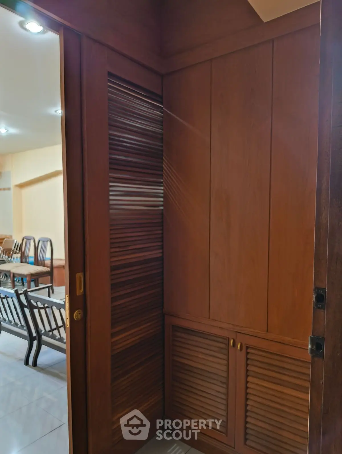 Elegant wooden storage area with sliding doors in a modern home interior