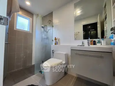 Modern bathroom with sleek fixtures and glass shower enclosure