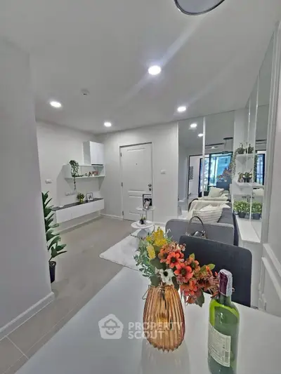 Modern living room with elegant decor and cozy ambiance, featuring stylish furniture and vibrant floral accents.