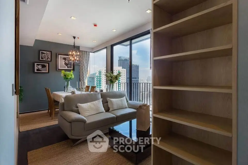 Modern living room with dining area and city view balcony in luxury apartment.