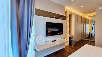 Modern bedroom with sleek TV setup and elegant lighting