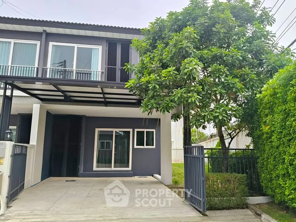 Modern two-story house with a spacious driveway and lush greenery, perfect for family living.