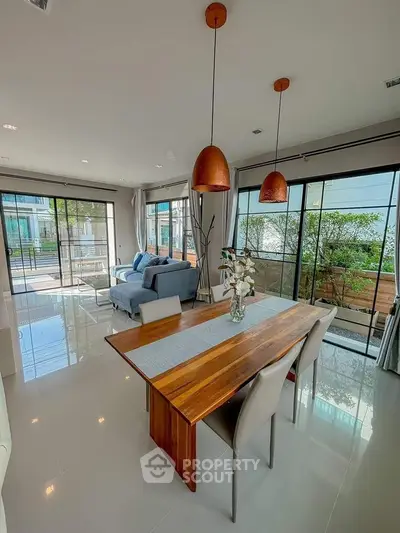 Spacious modern living room with elegant dining area and large windows