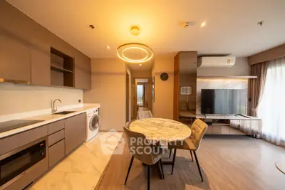 Modern open-layout kitchen and living area with stylish furniture and appliances