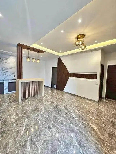 Luxurious modern living room with marble flooring and stylish lighting fixtures.