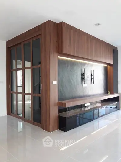 Modern living room with sleek wooden paneling and TV mount