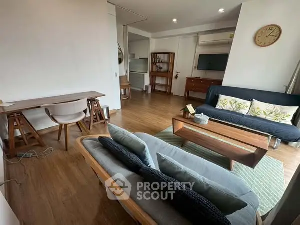 Spacious living room with modern furniture and wooden flooring