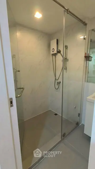 Modern bathroom with glass shower enclosure and sleek fixtures