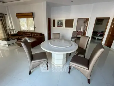 Spacious living room with elegant dining set and cozy seating area