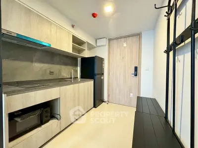 Modern kitchen with sleek cabinetry and appliances in a stylish apartment.