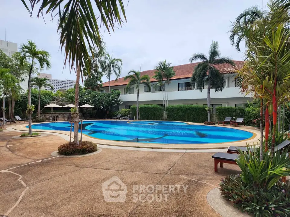 Luxurious tropical poolside with lush greenery and elegant loungers, perfect for relaxation and leisure.