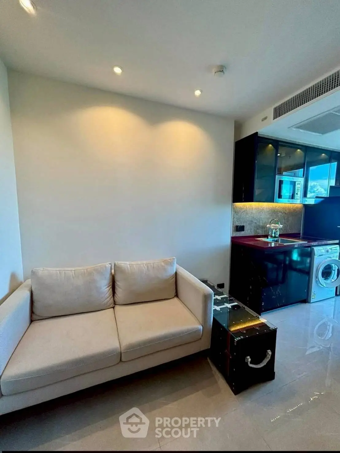 Modern apartment interior with sleek kitchen and cozy living area