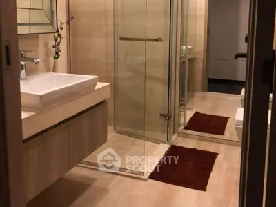 Elegant modern bathroom with glass shower and stylish sink