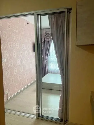 Charming bedroom with elegant curtains and stylish wallpaper, perfect for a cozy retreat.