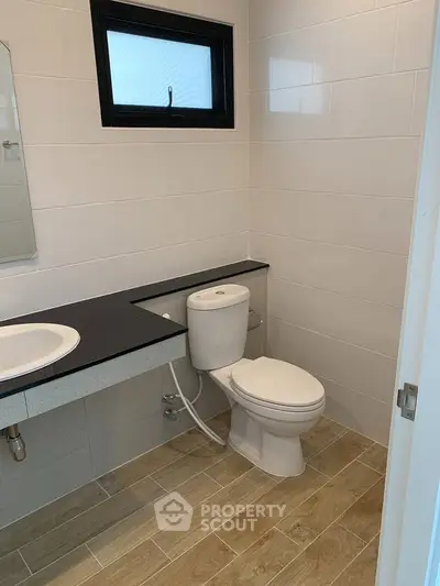Modern bathroom with sleek design and wooden flooring