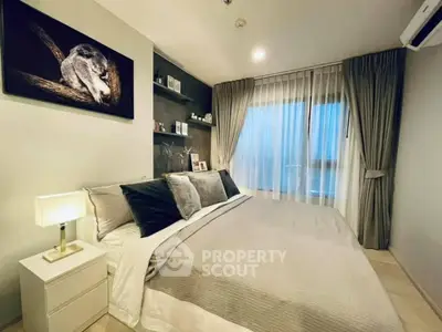 Luxurious bedroom with elegant decor and large window offering natural light.
