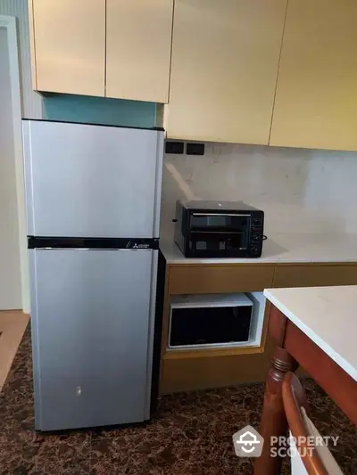 Modern kitchen with sleek fridge and appliances in stylish apartment