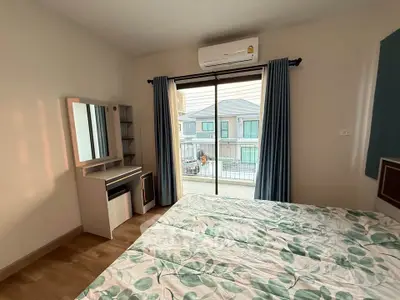 Cozy bedroom with balcony view and modern decor