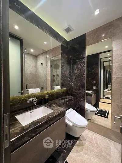 Luxurious modern bathroom with elegant marble finishes and sleek fixtures.
