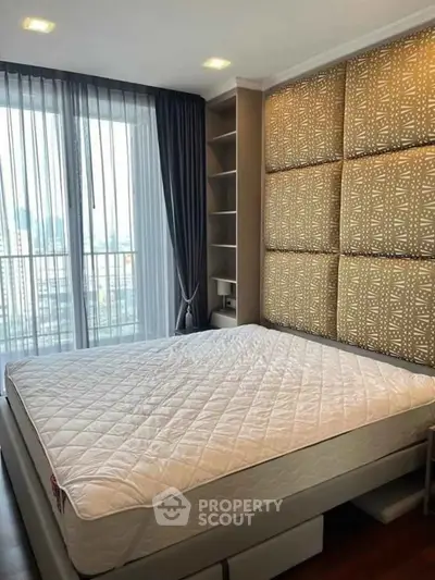Luxurious bedroom with large window and stylish decor in modern apartment