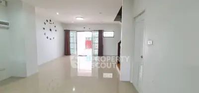 Spacious and bright living room with modern decor and large windows for natural light.