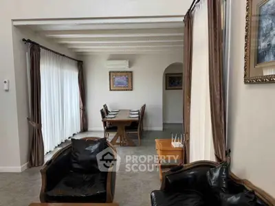 Elegant living and dining area with classic furniture and natural light