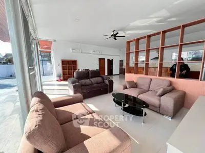 Spacious modern living room with large windows and stylish furniture