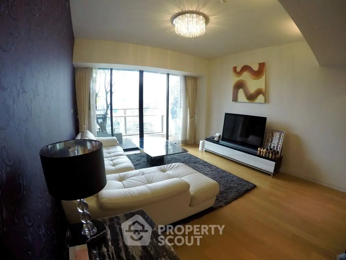 Luxurious living room with modern decor and large windows offering natural light.