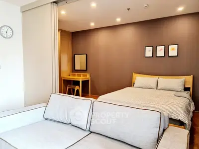 Modern studio apartment with cozy bed and stylish decor