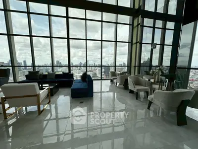 Luxurious high-rise living room with panoramic city views and elegant furnishings.