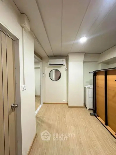 Modern interior with wooden flooring and air conditioning, ideal for cozy living space.