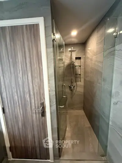 Modern bathroom with sleek shower design and elegant wood door