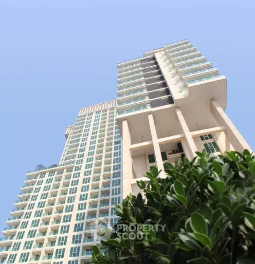 Stunning high-rise building with modern architecture and lush greenery