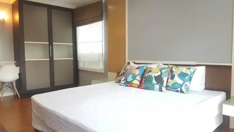 Modern bedroom with stylish decor and large wardrobe
