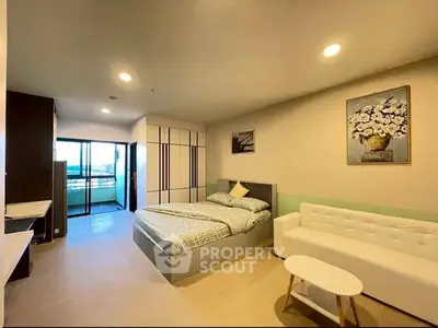 Spacious modern bedroom with balcony access and stylish decor