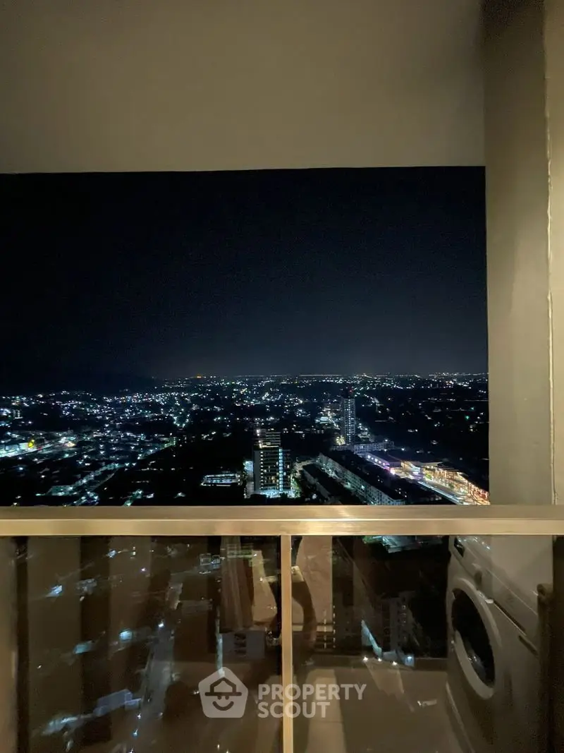 Stunning night city view from high-rise balcony with washing machine