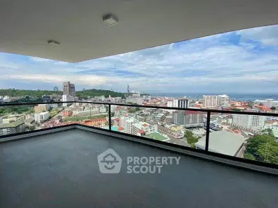 Spacious balcony with stunning cityscape and ocean views, perfect for relaxation and entertainment.