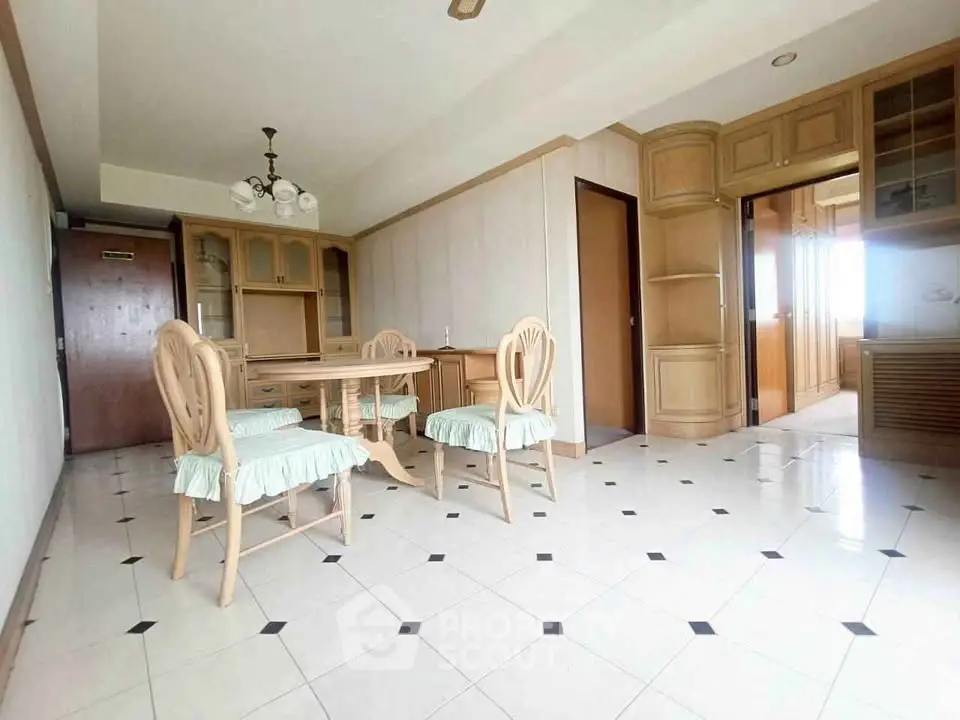 Spacious dining area with elegant wooden furniture and tiled flooring