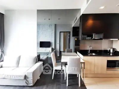 Modern open-plan living room and kitchen with sleek design and neutral tones.