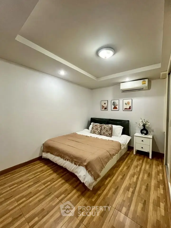 Cozy bedroom with modern decor and wooden flooring