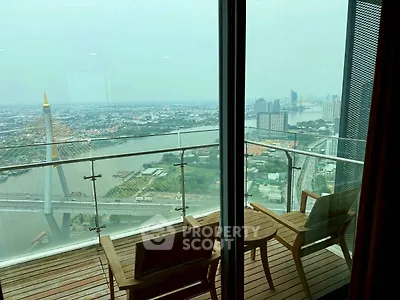 Stunning high-rise balcony with panoramic river and city views, featuring cozy seating for relaxation.
