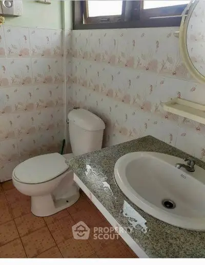 Charming vintage bathroom with unique tile design and classic fixtures.