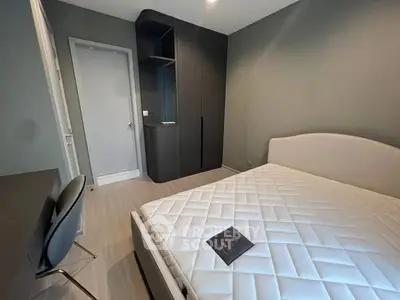 Modern bedroom with sleek design and minimalist furniture, featuring a comfortable bed and stylish wardrobe.