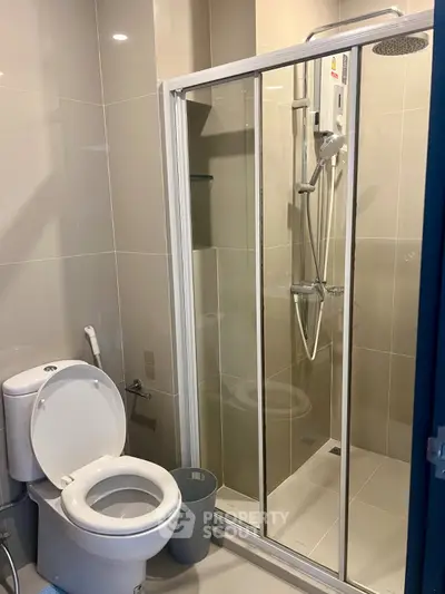 Modern bathroom with glass shower enclosure and sleek fixtures.