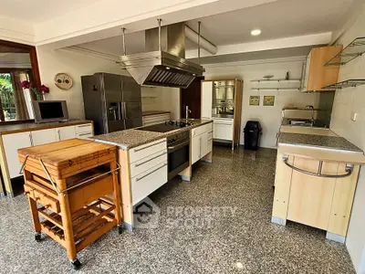 Spacious modern kitchen with granite countertops and stainless steel appliances